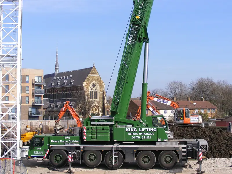 All-terrain crane with its boom raised on a city job site